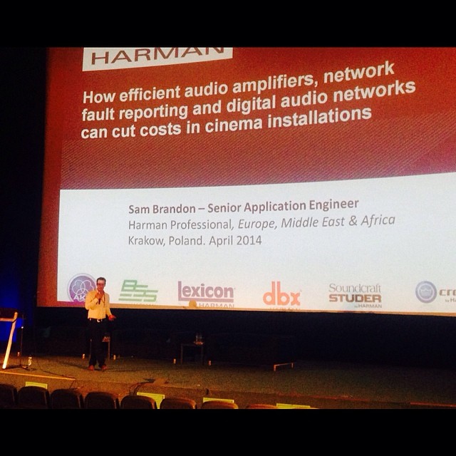 Sam presenting on a cinema-size screen to an audio audience