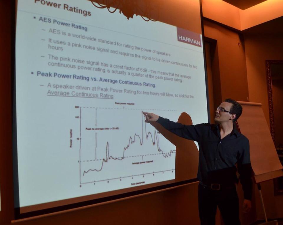 Sam pointing out engineering power ratings during a technical presentation