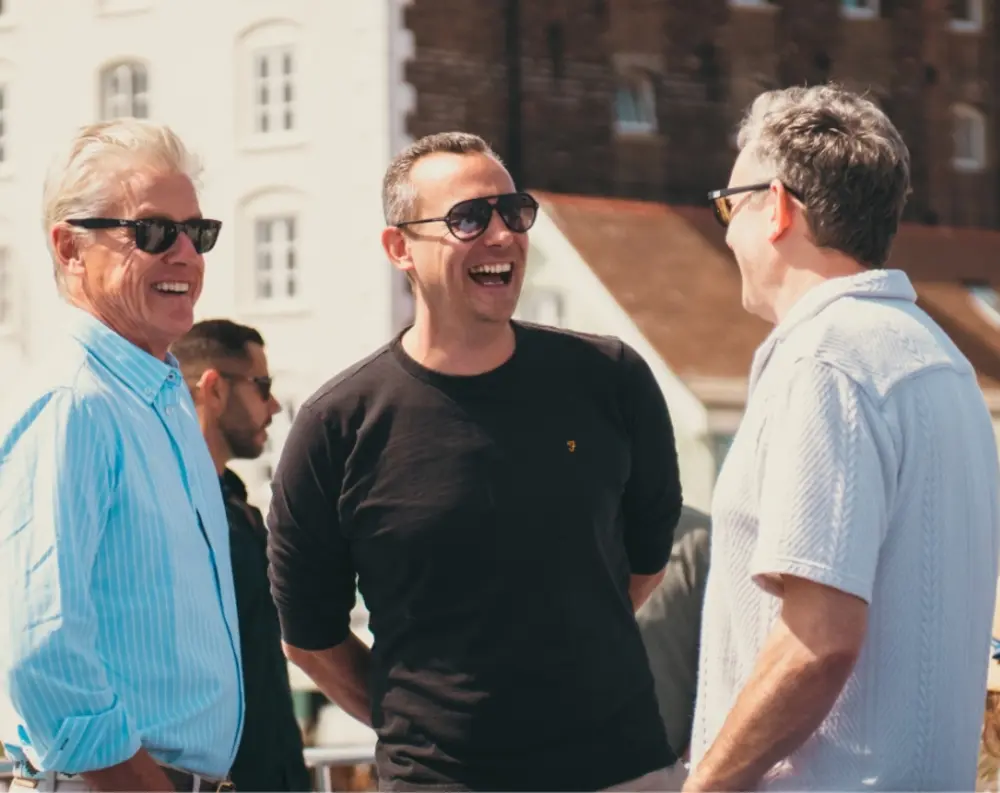 Sam in conversation with colleagues