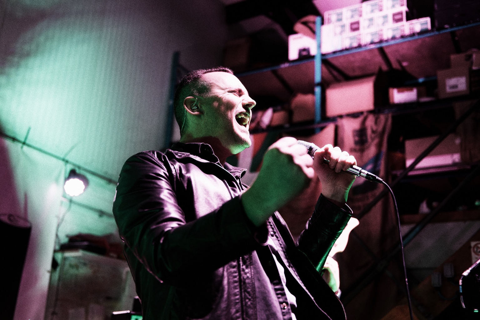 Sam performing live with a microphone