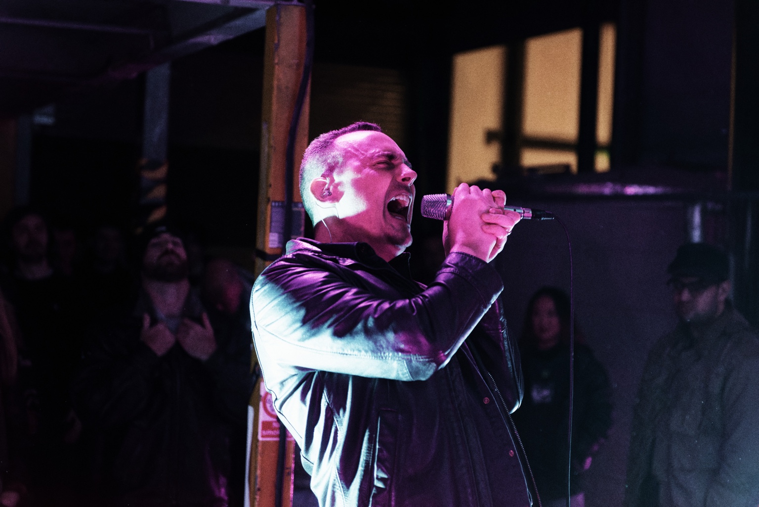 Sam Brandon performing live under purple lighting
